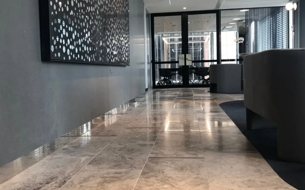 Commercial lobby with stone floor and reception wall
