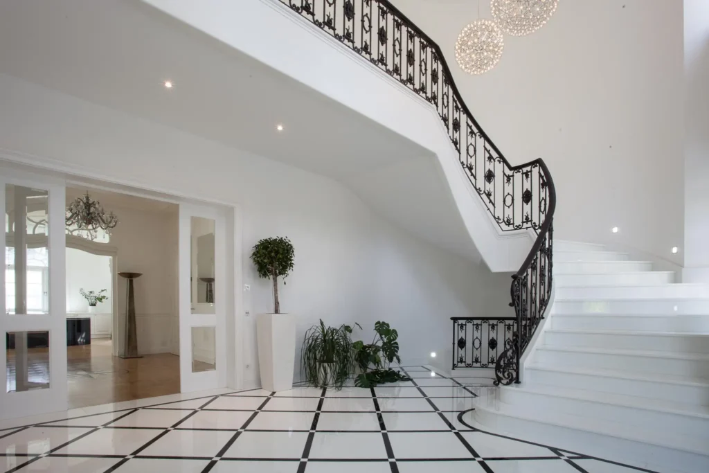 Interior with coordinated stone floor staircase and countertop