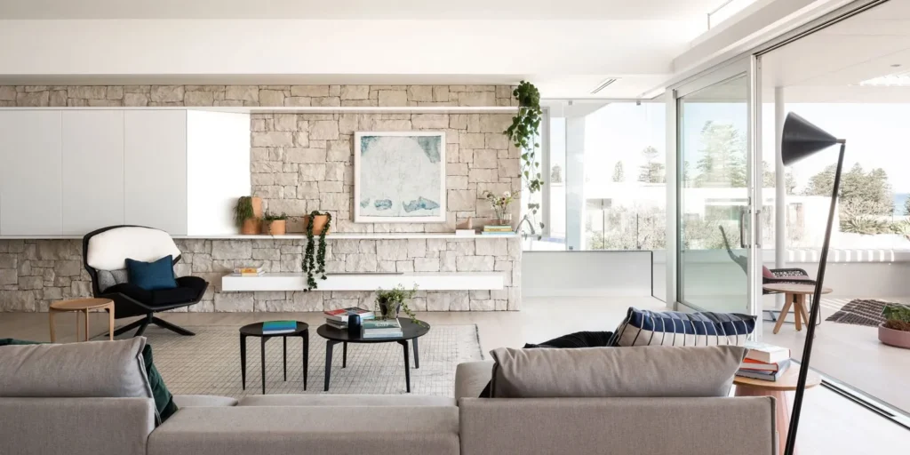 Residential living and dining area with stone floor and feature wall