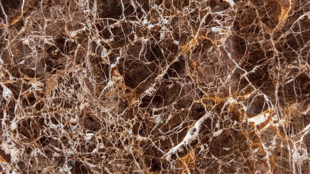 Brown marble surface with white and gold veining