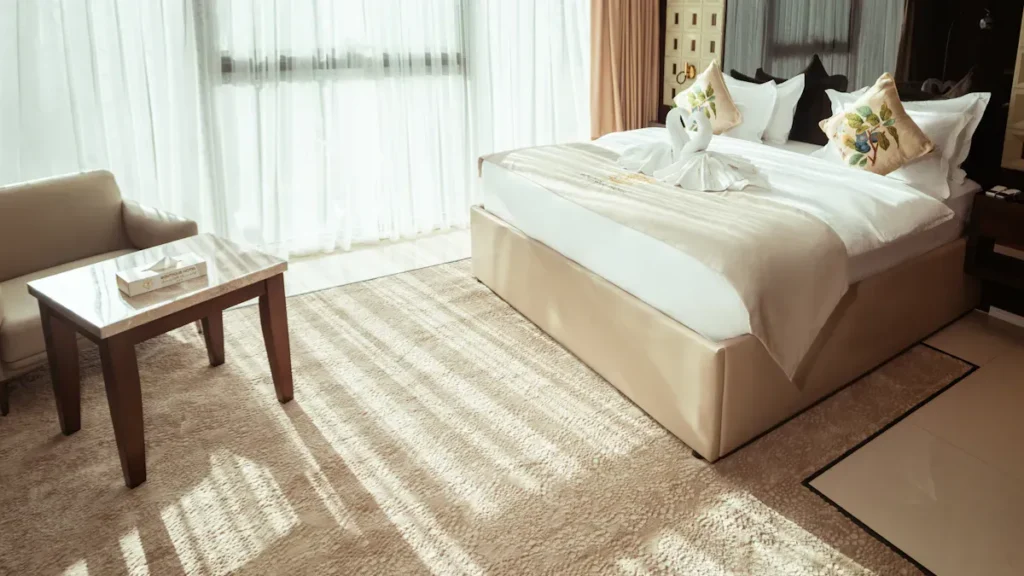 Hotel bedroom with curtains across a broad window