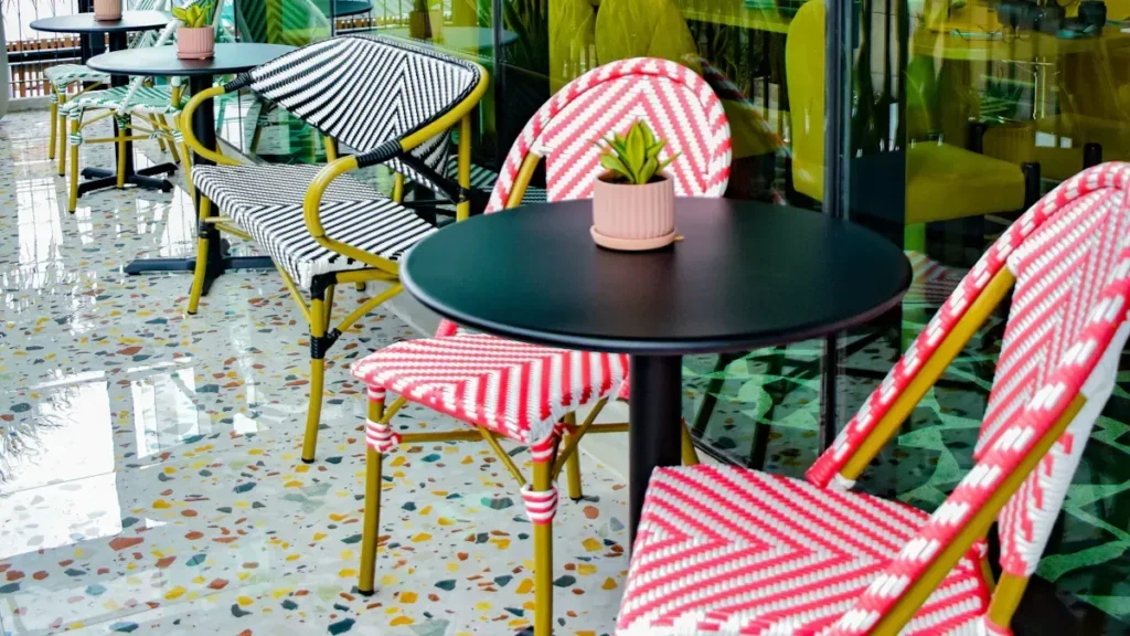 Colorful woven cafe chairs beside outdoor tables