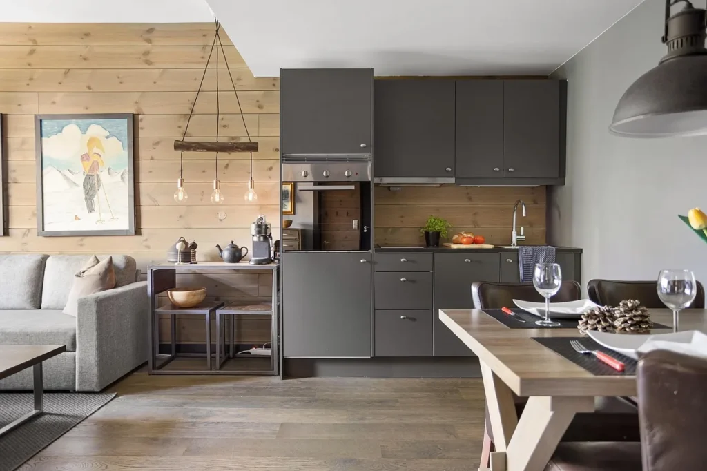 Dark kitchen cabinets in a living and dining area