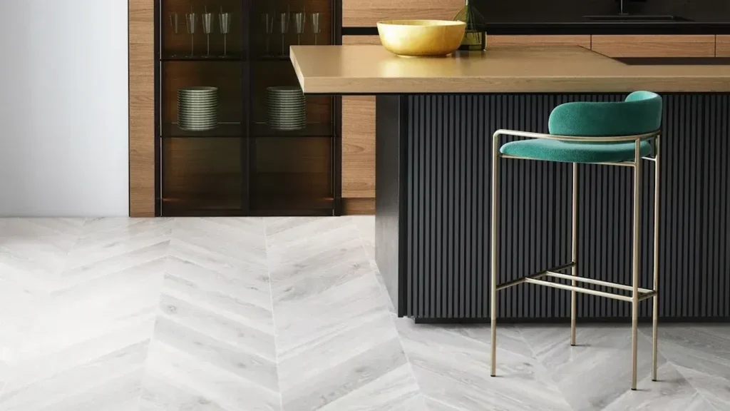 Dark kitchen cabinetry with a ribbed island and green stool