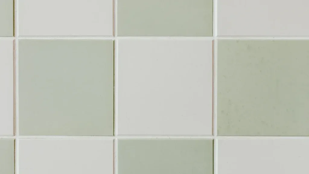 Grid of pale ceramic wall tiles with contrasting grout