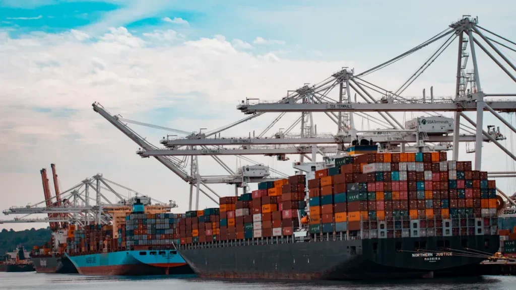 Container ship docked beneath port cranes