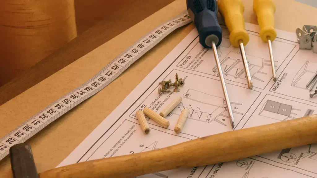Screwdrivers, screws and measuring tape on assembly drawings