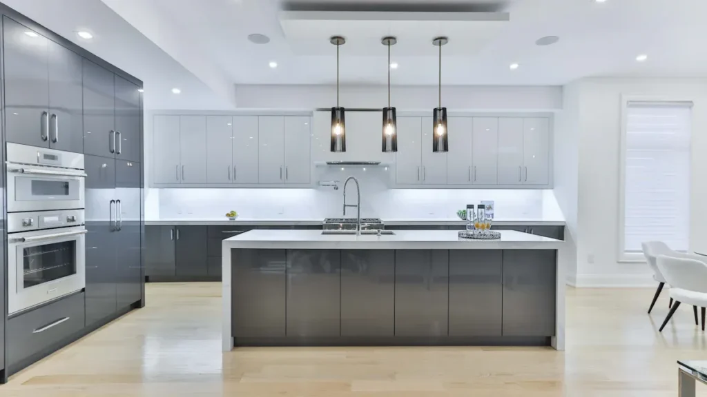 Gray kitchen cabinets surrounding a large central island