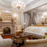 Ornate bedroom with pale furniture and chandeliers