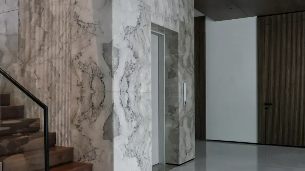 White veined marble walls beside an interior staircase
