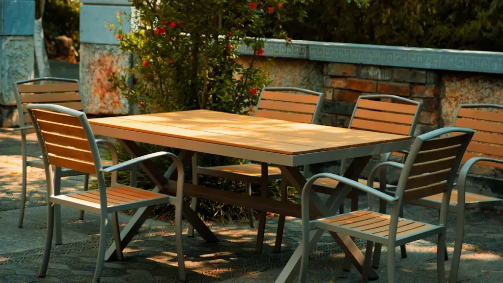 Outdoor wooden dining table with metal framed chairs