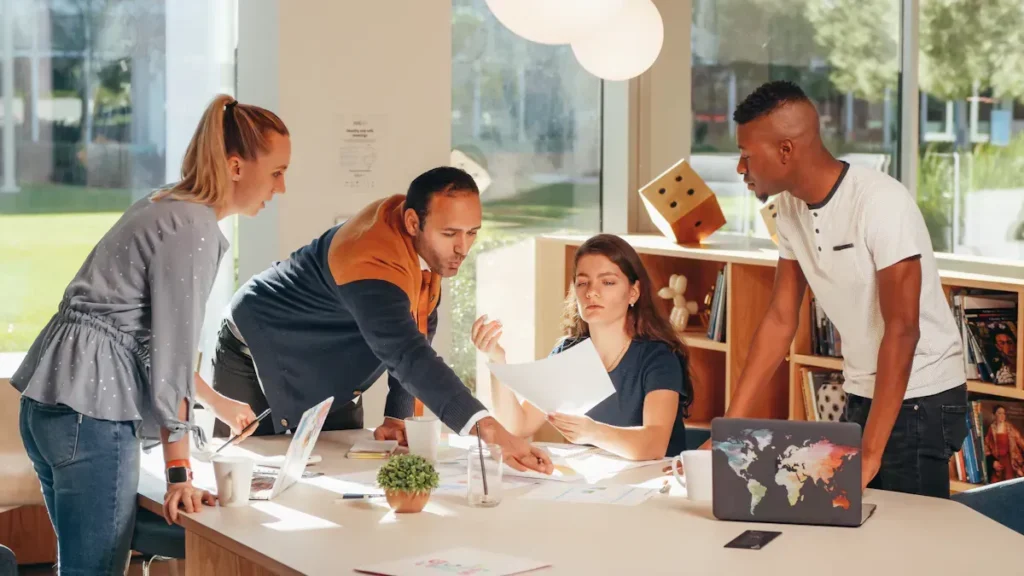 Design team reviewing plans together around a table