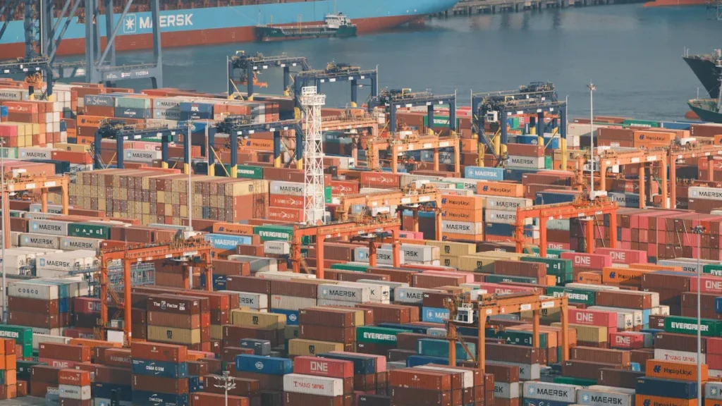 Shipping containers stacked at a busy port
