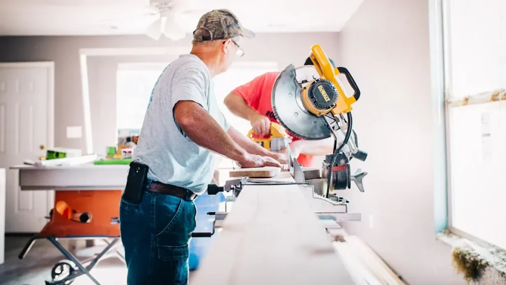 Worker cutting timber with a miter saw