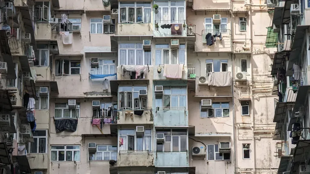 Apartment facade with windows, balconies and air conditioners